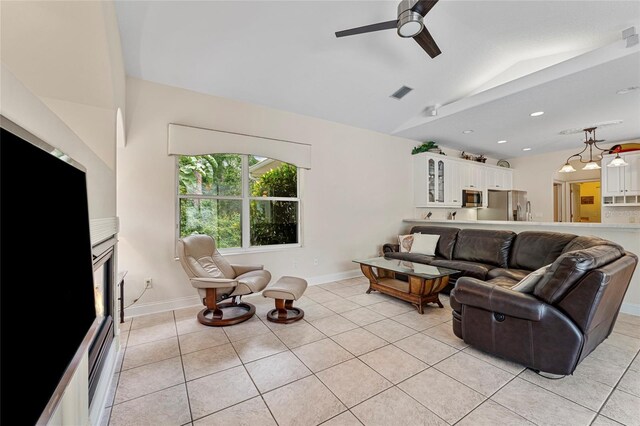68 Egret Trl, Palm Coast, FL 32164 - living room featuring lofted ceiling, ceiling fan, and light tile patterned floors