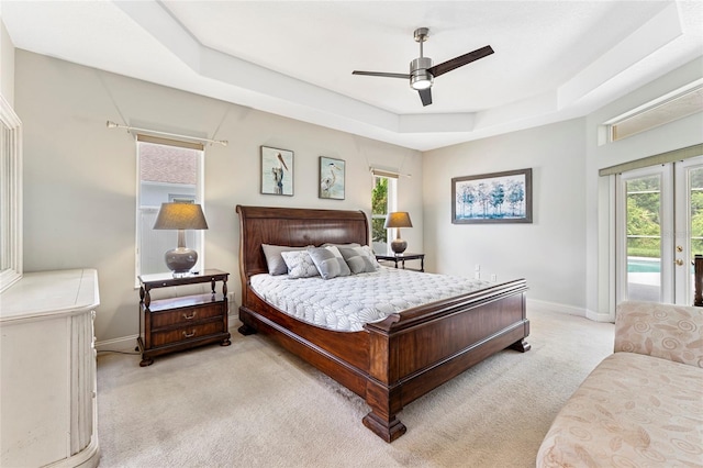 68 Egret Trl, Palm Coast, FL 32164 - carpeted bedroom featuring access to outside, a tray ceiling, and a ceiling fan