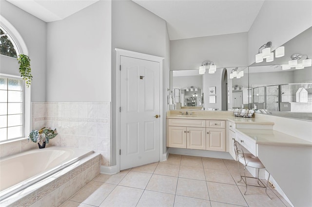 68 Egret Trl, Palm Coast, FL 32164 - full bath featuring vanity, a bath, tile patterned floors, and a stall shower