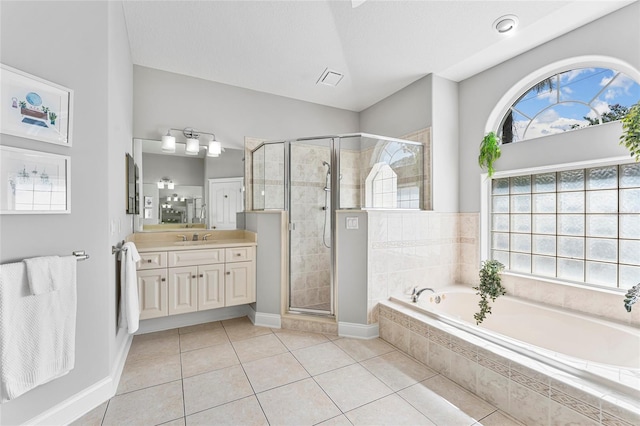 68 Egret Trl, Palm Coast, FL 32164 - bathroom featuring a garden tub, vanity, a stall shower, and tile patterned floors