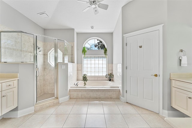 68 Egret Trl, Palm Coast, FL 32164 - bathroom with vanity, a garden tub, a stall shower, a ceiling fan, and a textured ceiling