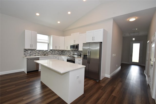 77 Green Cir, Palm Coast, FL 32164 - kitchen with stainless steel appliances, backsplash, light countertops, dark wood-type flooring, and a kitchen island
