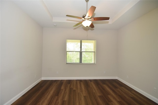 77 Green Cir, Palm Coast, FL 32164 - spare room with a raised ceiling, wood finished floors, and ceiling fan