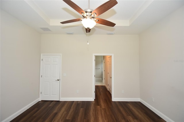 77 Green Cir, Palm Coast, FL 32164 - unfurnished bedroom featuring wood finished floors, a tray ceiling, and ceiling fan