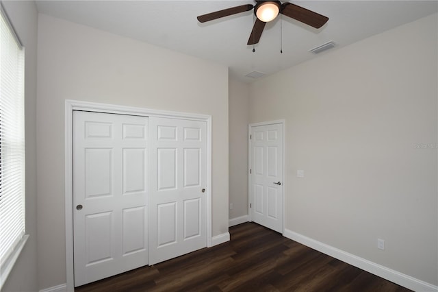 77 Green Cir, Palm Coast, FL 32164 - unfurnished bedroom with dark wood finished floors, a closet, and a ceiling fan