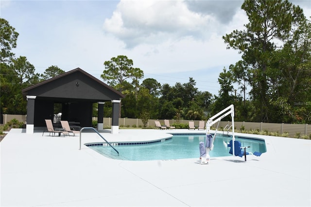 77 Green Cir, Palm Coast, FL 32164 - view of pool featuring a gazebo, a patio area, and view of wooded area
