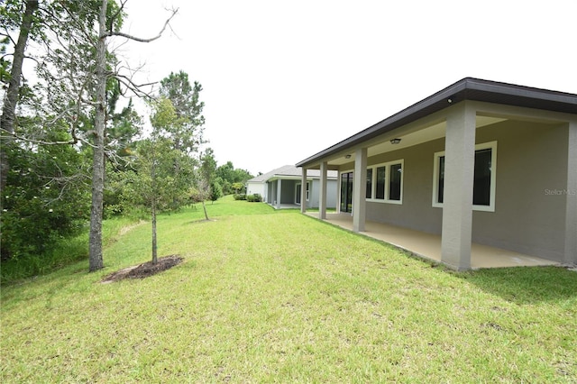 77 Green Cir, Palm Coast, FL 32164 - view of grassy yard featuring a patio