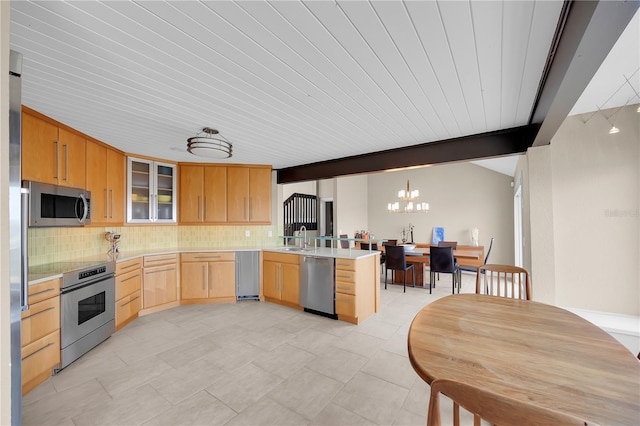9353 Old A1A, Saint Augustine, FL 32080 - kitchen with appliances with stainless steel finishes, light brown cabinets, a peninsula, tasteful backsplash, and wood ceiling