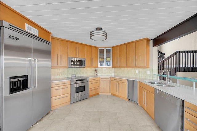9353 Old A1A, Saint Augustine, FL 32080 - kitchen with appliances with stainless steel finishes, light brown cabinets, tasteful backsplash, light countertops, and glass insert cabinets