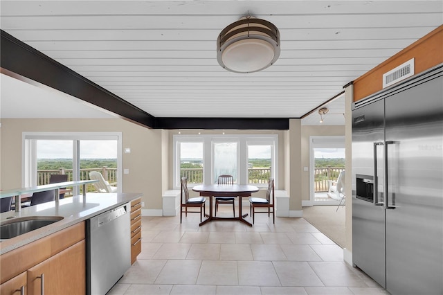 9353 Old A1A, Saint Augustine, FL 32080 - kitchen with stainless steel appliances, light countertops, and light tile patterned floors
