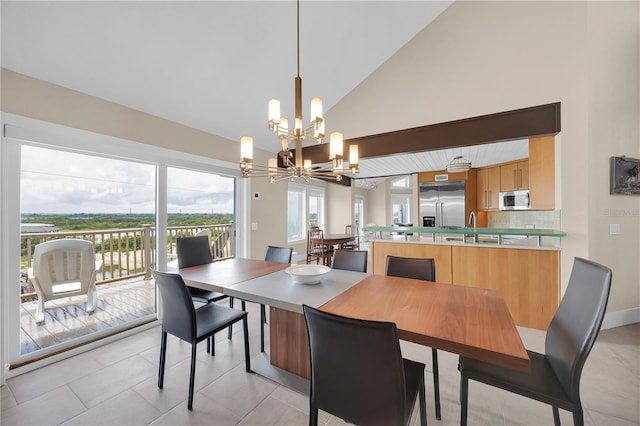 9353 Old A1A, Saint Augustine, FL 32080 - dining space featuring a chandelier, light tile patterned floors, and high vaulted ceiling