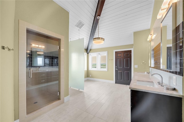 9353 Old A1A, Saint Augustine, FL 32080 - full bathroom featuring double vanity, a stall shower, beam ceiling, and tile patterned floors