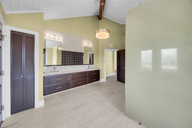 9353 Old A1A, Saint Augustine, FL 32080 - bathroom with a closet, double vanity, high vaulted ceiling, tile patterned floors, and backsplash