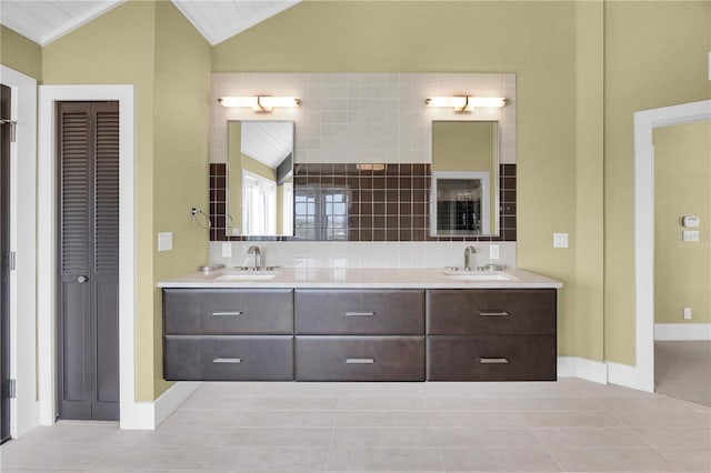 9353 Old A1A, Saint Augustine, FL 32080 - bathroom with vaulted ceiling, double vanity, a closet, and tile patterned flooring