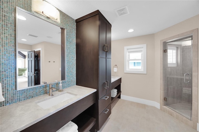 9353 Old A1A, Saint Augustine, FL 32080 - bathroom with vanity, a stall shower, tile patterned floors, decorative backsplash, and recessed lighting