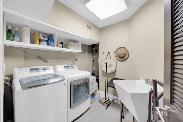 9353 Old A1A, Saint Augustine, FL 32080 - washroom featuring independent washer and dryer, light tile patterned floors, a textured wall, and electric panel