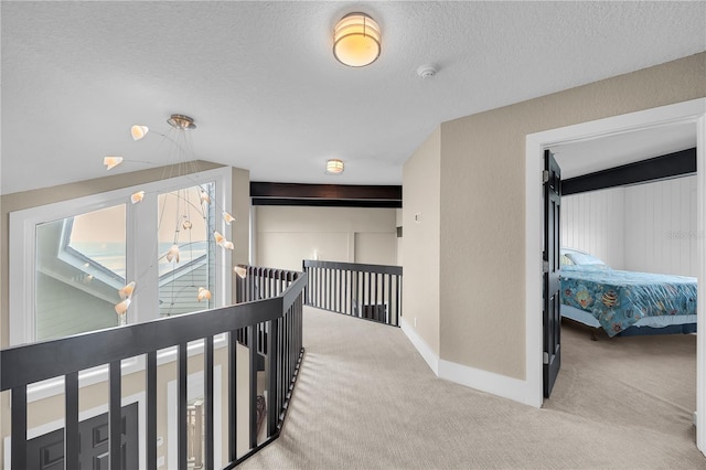9353 Old A1A, Saint Augustine, FL 32080 - corridor with an upstairs landing, carpet floors, and a textured ceiling