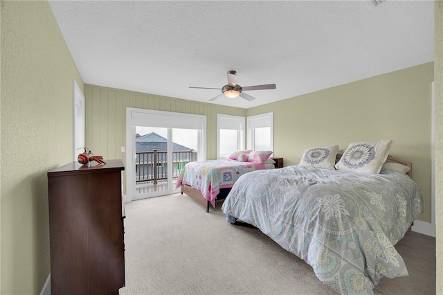9353 Old A1A, Saint Augustine, FL 32080 - bedroom featuring access to exterior, ceiling fan, a textured wall, carpet flooring, and a textured ceiling
