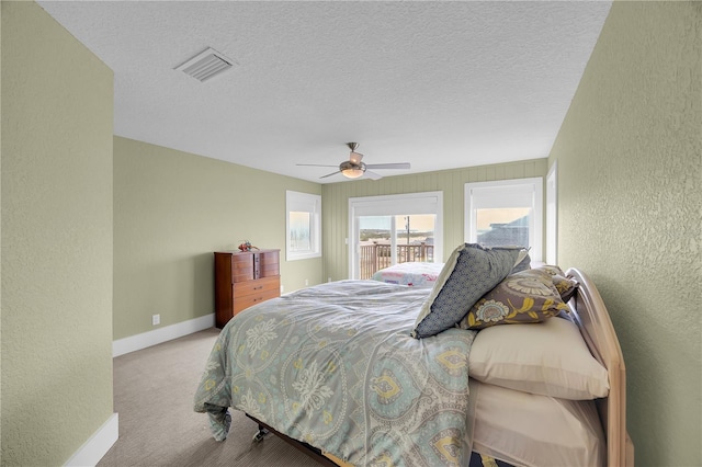 9353 Old A1A, Saint Augustine, FL 32080 - bedroom with a textured wall, carpet, a ceiling fan, a textured ceiling, and access to outside