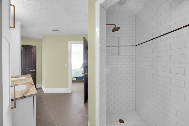 9353 Old A1A, Saint Augustine, FL 32080 - full bath with a stall shower, double vanity, tile patterned floors, ensuite bathroom, and a textured ceiling