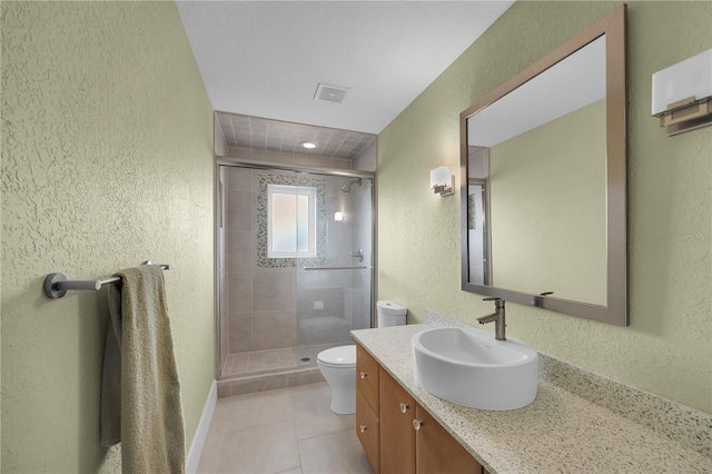 9353 Old A1A, Saint Augustine, FL 32080 - full bathroom with a textured wall, vanity, a shower stall, and tile patterned floors