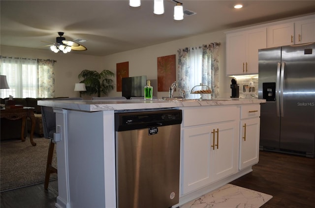 35 Putter Dr, Palm Coast, FL 32164 - kitchen with appliances with stainless steel finishes, white cabinetry, a ceiling fan, an island with sink, and recessed lighting