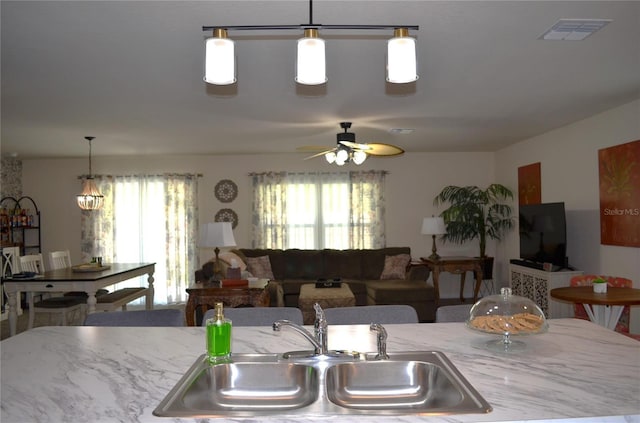 35 Putter Dr, Palm Coast, FL 32164 - kitchen with ceiling fan, healthy amount of natural light, hanging light fixtures, and open floor plan
