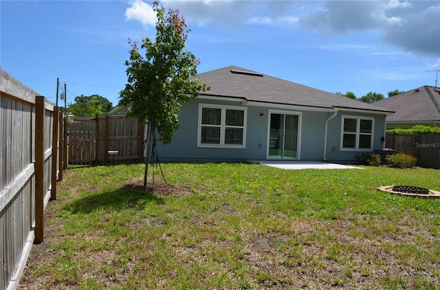 35 Putter Dr, Palm Coast, FL 32164 - back of property featuring a fenced backyard, a patio area, stucco siding, and a shingled roof