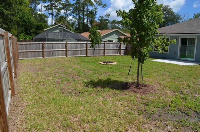 35 Putter Dr, Palm Coast, FL 32164 - fenced backyard with a fire pit and a patio