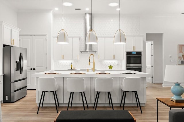 476 Stirling Bridge Dr, Ormond Beach, FL 32174 - kitchen featuring appliances with stainless steel finishes, tasteful backsplash, light countertops, a kitchen island with sink, and white cabinetry