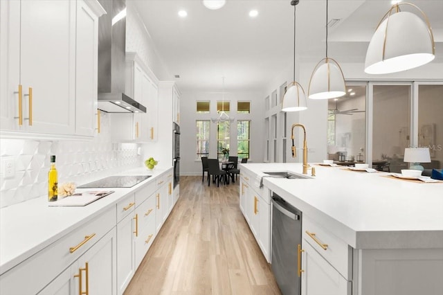 476 Stirling Bridge Dr, Ormond Beach, FL 32174 - kitchen featuring black appliances, wall chimney exhaust hood, light wood finished floors, white cabinets, and light countertops