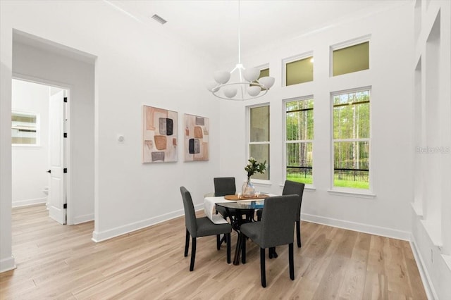 476 Stirling Bridge Dr, Ormond Beach, FL 32174 - dining room with light wood finished floors and a chandelier