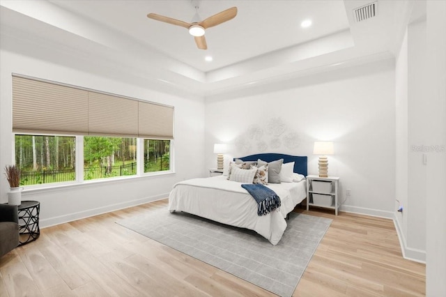 476 Stirling Bridge Dr, Ormond Beach, FL 32174 - bedroom featuring a raised ceiling, wood finished floors, recessed lighting, and ceiling fan