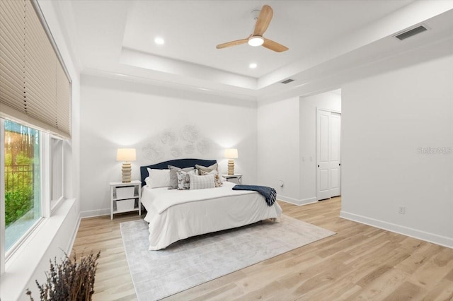 476 Stirling Bridge Dr, Ormond Beach, FL 32174 - bedroom with a tray ceiling, light wood finished floors, recessed lighting, and a ceiling fan