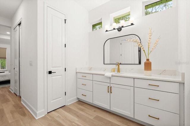476 Stirling Bridge Dr, Ormond Beach, FL 32174 - bathroom featuring vanity, wood finished floors, ensuite bath, and plenty of natural light