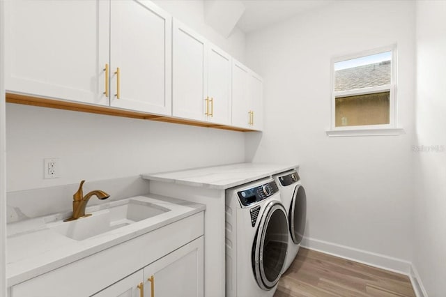 476 Stirling Bridge Dr, Ormond Beach, FL 32174 - laundry area featuring washer and clothes dryer, cabinet space, and light wood finished floors