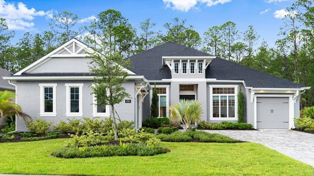 476 Stirling Bridge Dr, Ormond Beach, FL 32174 - view of front of house with a garage, decorative driveway, a front yard, and stucco siding