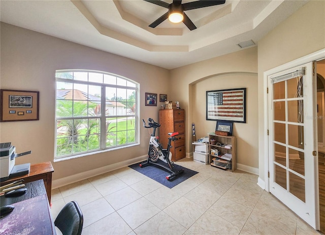 8 Wiltshire Pl, Palm Coast, FL 32164 - exercise area featuring ceiling fan, a tray ceiling, and light tile patterned floors