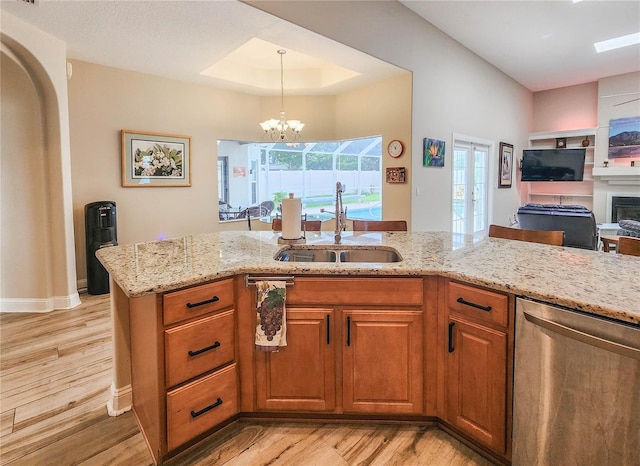 8 Wiltshire Pl, Palm Coast, FL 32164 - kitchen featuring stainless steel dishwasher, light wood-style floors, light stone countertops, and open floor plan