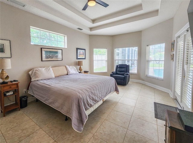 8 Wiltshire Pl, Palm Coast, FL 32164 - bedroom with light tile patterned floors, multiple windows, and a tray ceiling