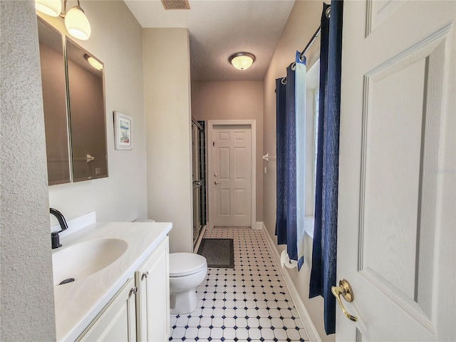 8 Wiltshire Pl, Palm Coast, FL 32164 - bathroom with vanity, a shower with shower door, and tile patterned floors