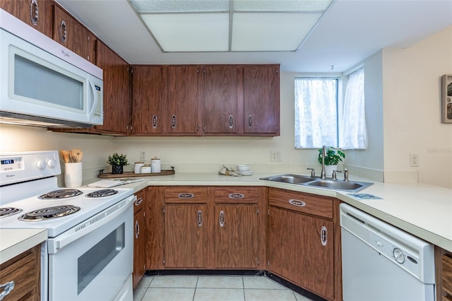 11 Surrey Ct Unit 11, Palm Coast, FL 32137 - kitchen featuring white appliances, light countertops, and light tile patterned floors