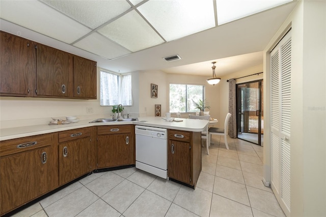 11 Surrey Ct Unit 11, Palm Coast, FL 32137 - kitchen with dishwasher, a peninsula, light countertops, and light tile patterned floors
