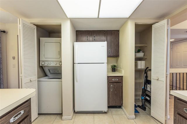 11 Surrey Ct Unit 11, Palm Coast, FL 32137 - washroom featuring estacked washer and dryer and light tile patterned flooring