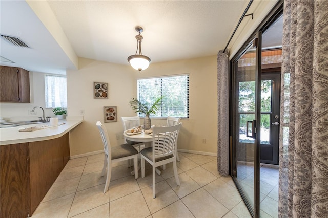 11 Surrey Ct Unit 11, Palm Coast, FL 32137 - dining room featuring healthy amount of natural light and light tile patterned flooring
