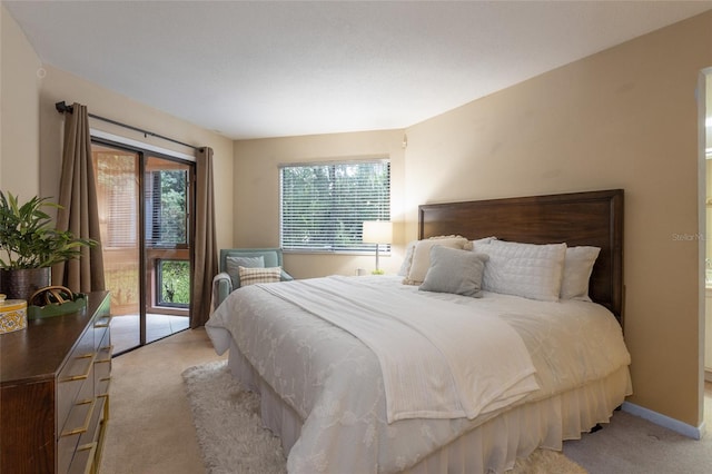 11 Surrey Ct Unit 11, Palm Coast, FL 32137 - bedroom featuring light colored carpet and access to exterior