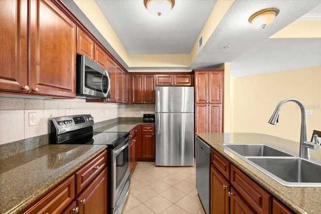 200 Ocean Crest Dr Unit 813, Palm Coast, FL 32137 - kitchen with stainless steel appliances, light tile patterned floors, decorative backsplash, and dark stone counters