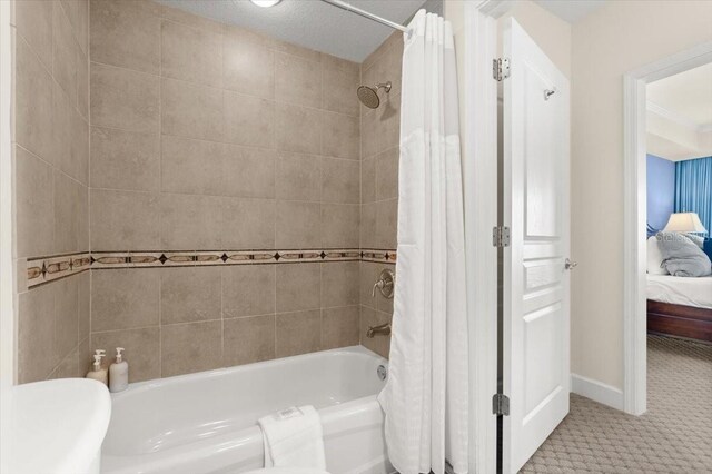 200 Ocean Crest Dr Unit 813, Palm Coast, FL 32137 - ensuite bathroom with shower / tub combo with curtain and baseboards