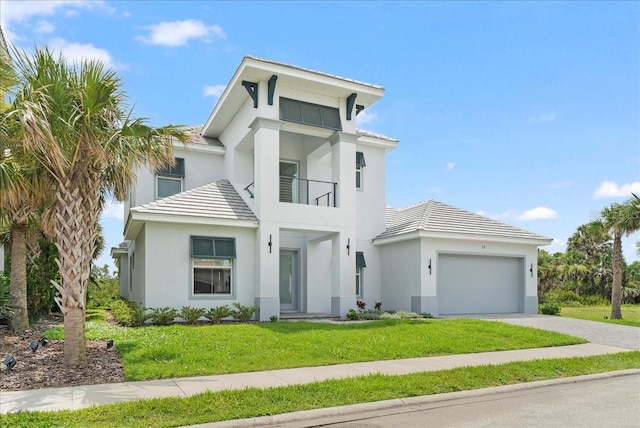 23 Ocean Ridge Blvd N, Palm Coast, FL 32137 - view of front of home with stucco siding, driveway, a front yard, a garage, and a balcony