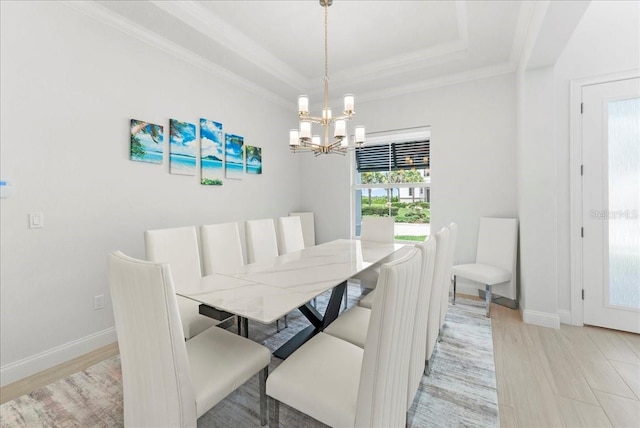 23 Ocean Ridge Blvd N, Palm Coast, FL 32137 - dining area with a chandelier, light wood-style flooring, a raised ceiling, and crown molding